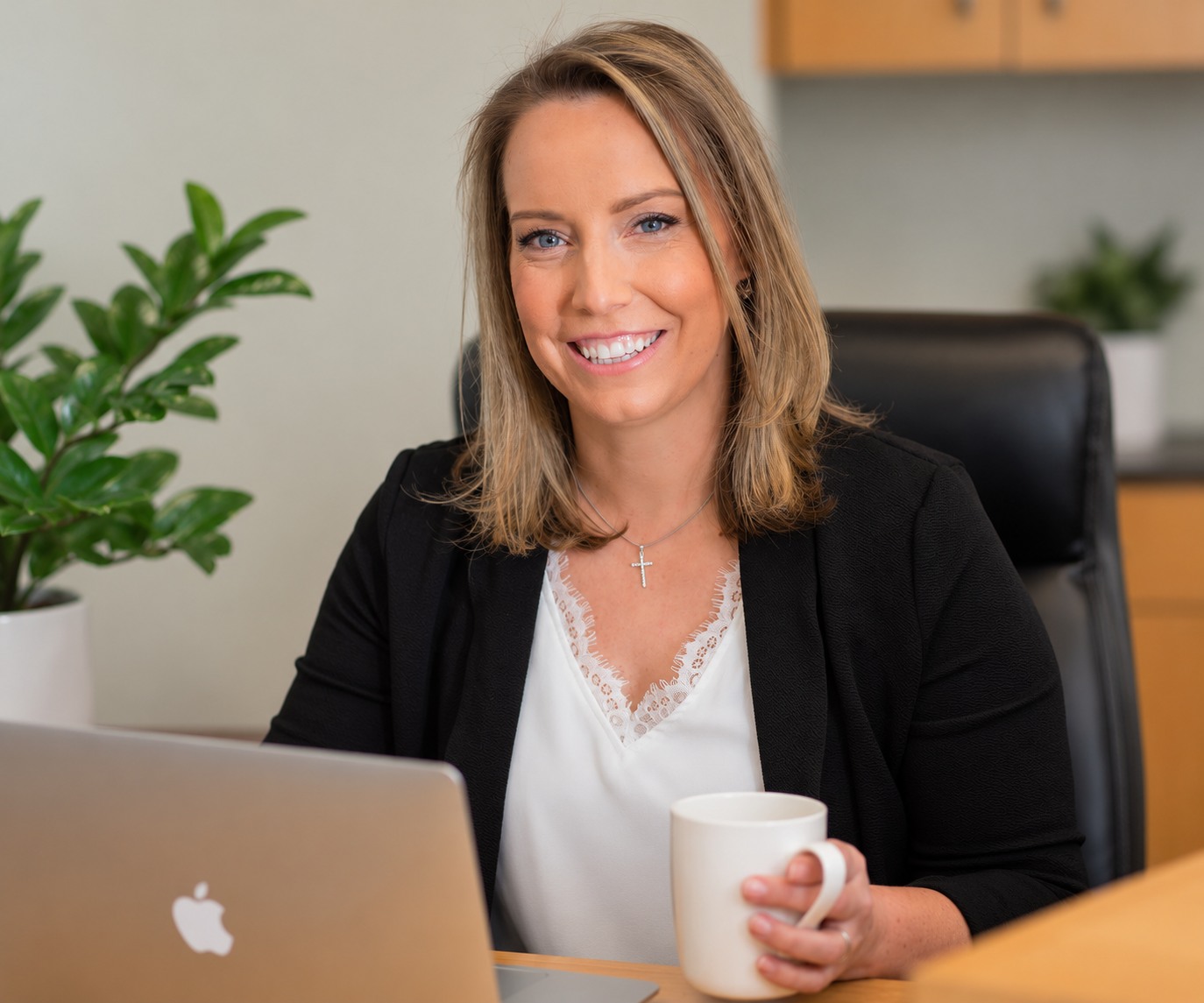 Renee Mallari smiling in her office